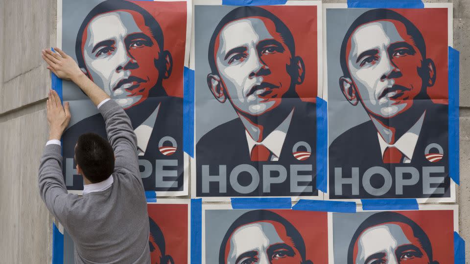 A Barack Obama supporter puts up posters showing one of the most popular images associated with Obama's first presidential campaign. - Robert Daemmrich Photography Inc/Corbis/Getty Images