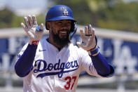 Los Angeles Dodgers' Teoscar Hernández gestures to teammates in the dugout as he rounds third after hitting a two-run home run during the sixth inning of a baseball game against the Miami Marlins Wednesday, May 8, 2024, in Los Angeles. (AP Photo/Mark J. Terrill)