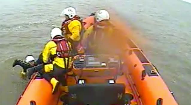 The crew pull the woman on board the rescue vessel. Source: RNLI