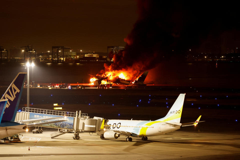 一架日本航空班機2日降落在日本羽田機場時疑似擦撞海上保安廳的飛機，隨後在跑道上起火燃燒。（路透社）