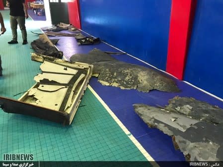 The purported wreckage of the American drone is seen displayed by the Islamic Revolution Guards Corps (IRGC) in Tehran