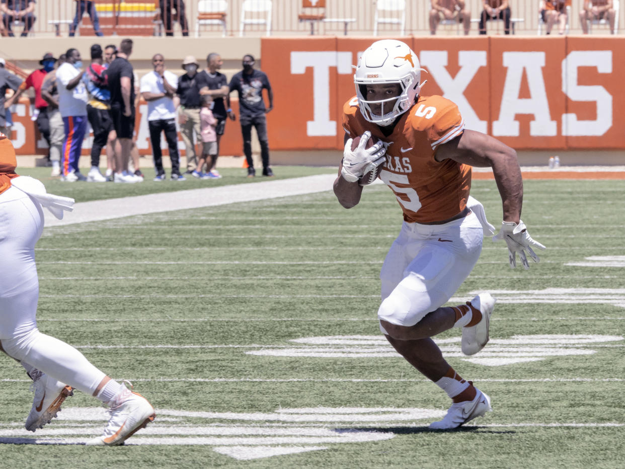 Texas running back Bijan Robinson (5) runs during the final half of the Texas Orange and White Spring Scrimmage in Austin, Texas, Saturday, April 24, 2021. (AP Photo/Michael Thomas)