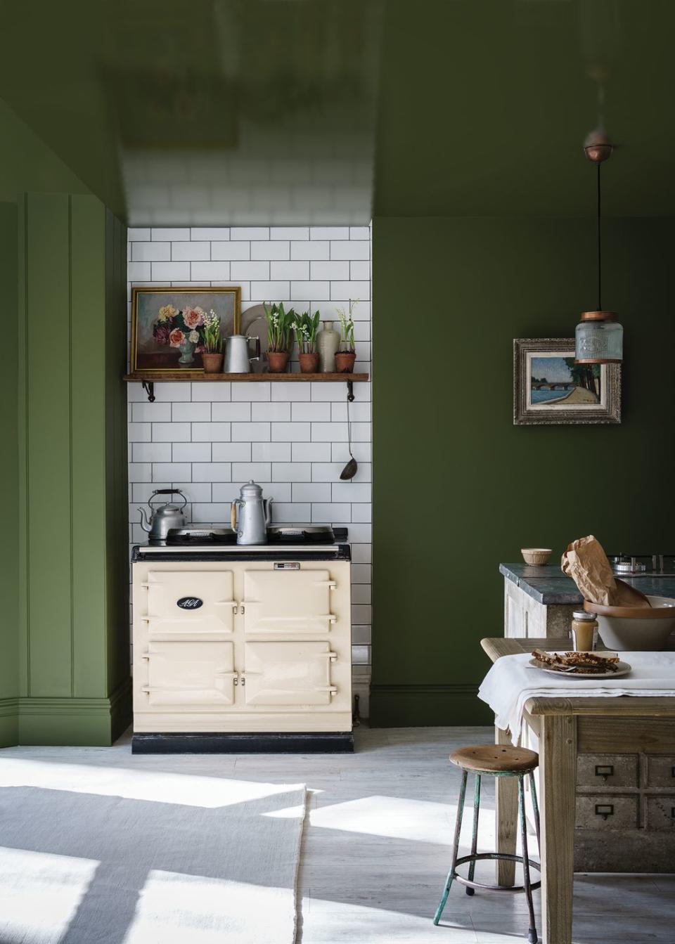 <p>This is the kind of kitchen where you could simply spend hours trialing new recipes. Awash in a delectable fern green, both the ceiling and walls help to create a space that feels incredibly grown-up. There's nothing low-key to see here and that's why we love it. </p><p><strong>READ MORE: </strong><a href="https://www.housebeautiful.com/uk/decorate/walls/a23351539/farrow-and-ball-new-paint-colours/" rel="nofollow noopener" target="_blank" data-ylk="slk:Farrow & Ball launch nine new paint colours;elm:context_link;itc:0;sec:content-canvas" class="link ">Farrow & Ball launch nine new paint colours </a></p><p>• Shop the look at <a href="https://www.farrow-ball.com/" rel="nofollow noopener" target="_blank" data-ylk="slk:Farrow & Ball;elm:context_link;itc:0;sec:content-canvas" class="link ">Farrow & Ball</a>. This paint is in the shade 'Bancha No.298'</p>