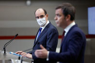 French Prime Minister Jean Castex, left, looks on as French Health Minister Olivier Veran speaks during a press conference in Paris, Thursday, Jan. 14, 2021. Trying to fend off the need for a third nationwide lockdown that would further dent Europe's second-largest economy and endanger more jobs, France is instead opting for creeping curfews. The prime minister announced Thursday an extension of the 6 p.m.-to-6 a.m. curfew to cover the whole country. (Thomas Coex, Pool Photo via AP)