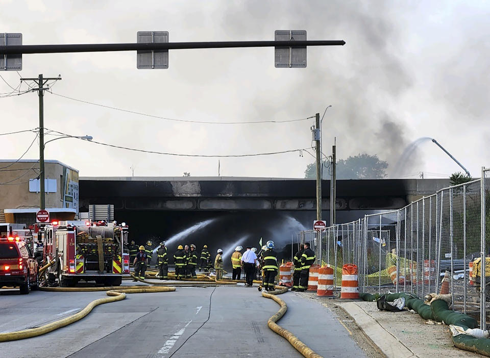 This image provided by the Philadelphia Fire Department shows officials working on the scene following a truck fire on I-95, Sunday, June 11, 2023, in Philadelphia. The elevated section of Interstate 95 has collapsed early Sunday after a vehicle caught fire, closing the main north-south highway on the East Coast and threatening to upend travel in parts of the densely populated Northeast. (Philadelphia Fire Department via AP)