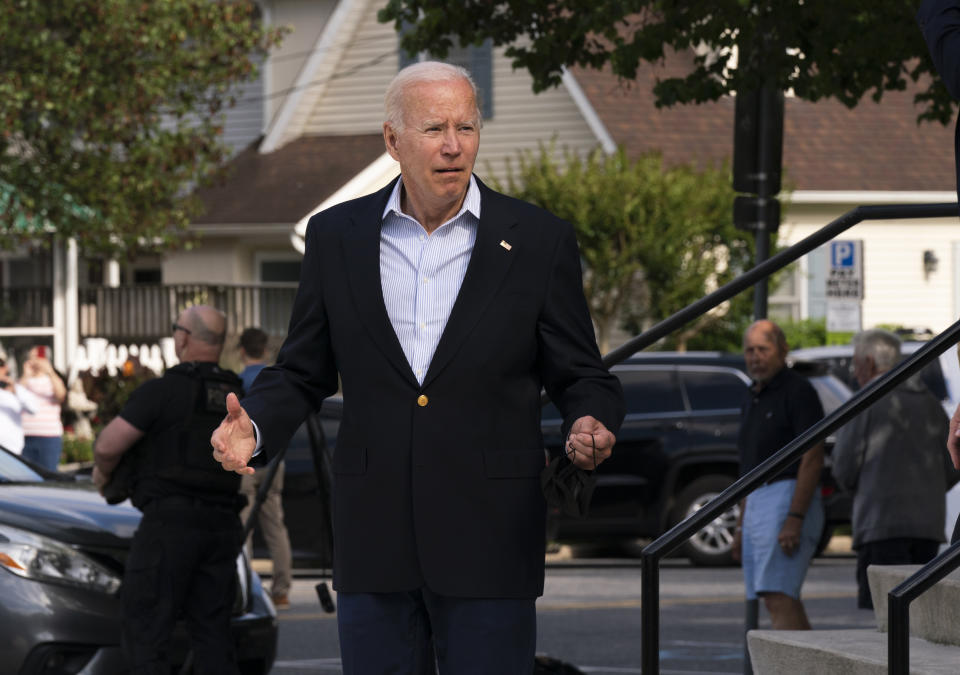President Joe Biden reacts when asked how he was feeling as he leaves St. Edmund Roman Catholic Church in Rehoboth Beach, Del., after attending a Mass, Saturday, June 18, 2022. Bystanders cheered as he was asked how he was feeling. He smiled, and took three hops forward, making a jump-rope motion with his hands. (AP Photo/Manuel Balce Ceneta)