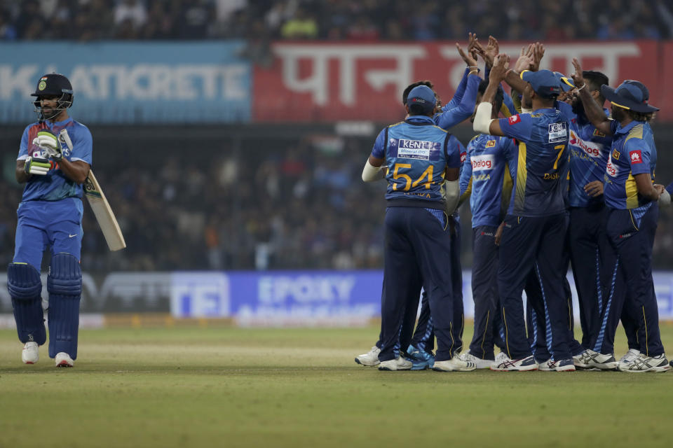 Sri Lankan players celebrate the dismissal of India's Shikhar Dhawan, left, during the second Twenty20 international cricket match between India and Sri Lanka in Indore, India, Tuesday, Jan. 7, 2020. (AP Photo/Aijaz Rahi)
