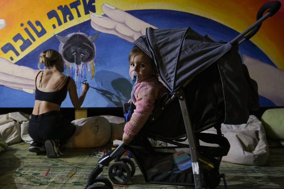 Sunny Volkov paints a mural on the Mushroom Project; a stage and production at the Nova festival, by her daughter Lian Vaknin. Her husband was killed at the Nova music festival.