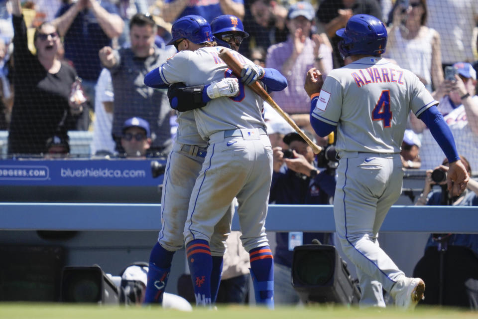New York Mets' Brandon Nimmo (9) celebrates with shortstop Francisco Lindor, left, after hitting a home run during the fifth inning of a baseball game against the Los Angeles Dodgers in Los Angeles, Wednesday, April 19, 2023. Francisco Alvarez (4) also scored. (AP Photo/Ashley Landis)