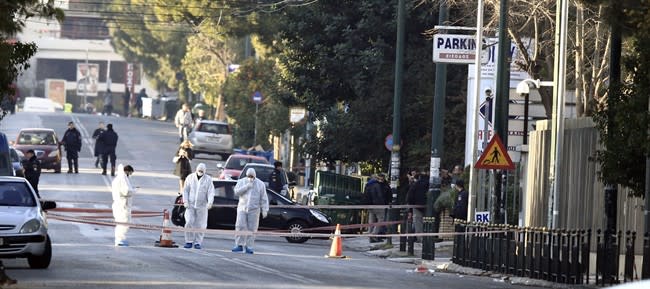 Police investigate a street outside the residence of German Ambassador to Athens Wolfgang Dold, in the northern suburb of Halandri, Greece Monday, Dec. 30, 2013. Police in Greece said the home of Germany’s ambassador was sprayed with gunfire from automatic weapons in an overnight attack that caused no injuries. (AP Photo/Thanassis Stavrakis)