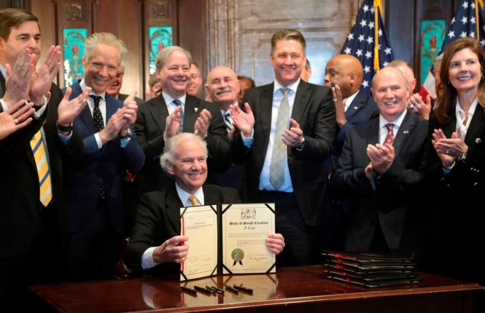 South Carolina Gov. Henry McMaster is surrounded by Scout Motors executives and State officials during a bill signing ceremony at the South Carolina State House in on Monday, March. 20, 2023. Tracy Glantz/tglantz@thestate.com