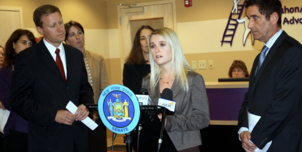 Erin Merryn, center, flanked by Senators David J. Valesky, left, and Jeffrey D. Klein, at the New York state senate discussing Erin's Law in October 2011. <a href="https://www.nysenate.gov/newsroom/press-releases/2011/jeffrey-d-klein/senators-valesky-klein-bring-erin-merryns-law-ny-state" rel="nofollow noopener" target="_blank" data-ylk="slk:New York State Senate;elm:context_link;itc:0;sec:content-canvas" class="link ">New York State Senate</a>