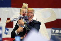 <p>Republican presidential candidate Donald Trump holds up a child he pulled from the crowd as he arrives to speak at a campaign rally in New Orleans, March 4, 2016. <i>(Photo: Gerald Herbert/AP)</i> </p>