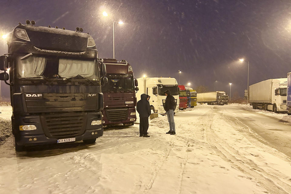 Ukrainian truck drivers wait to cross from Poland back into Ukraine in Korczowa, Poland, on Thursday Dec. 7, 2023. Ukrainian charities and companies supplying the country’s military warn that problems are growing as Polish truck drivers show no sign of ending a monthlong border blockade. (AP Photo/Karl Ritter)