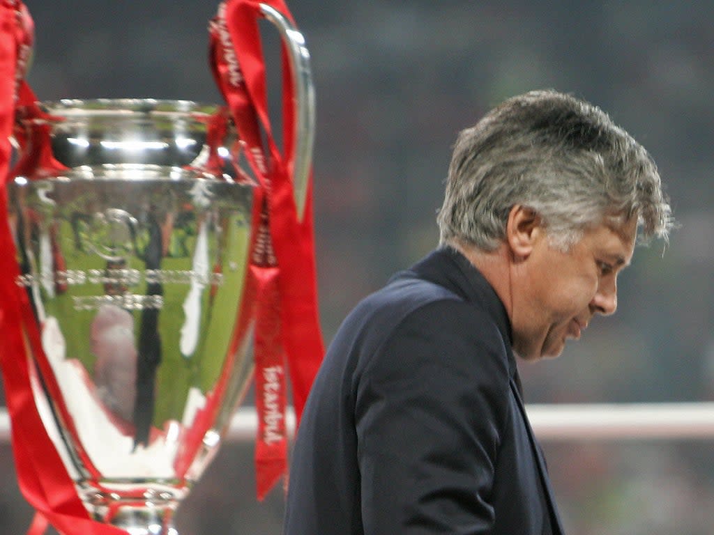 Carlo Ancelotti walks past the Champions League trophy in 2005 (AFP via Getty Images)