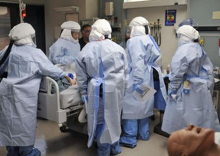 Participants practise a medical procedure on a dummy during training for the Ebola response team at Fort Sam Houston in San Antonio, Texas October 24, 2014. REUTERS/Darren Abate