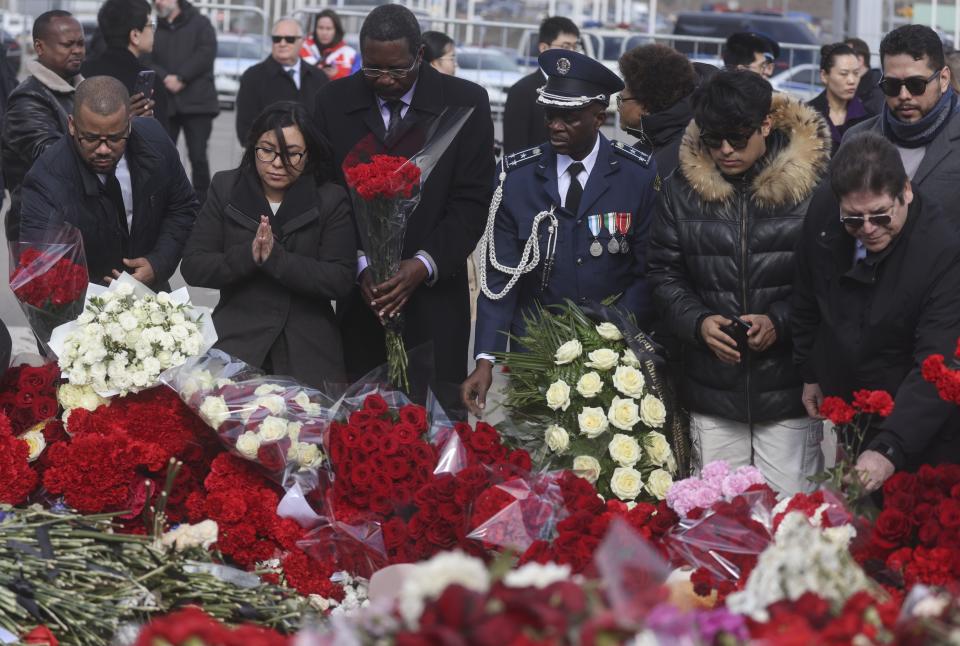 A group of ambassadors of foreign diplomatic missions attend a laying ceremony at a makeshift memorial in front of the Crocus City Hall on the western outskirts of Moscow, Russia, Saturday, March 30, 2024. (Sergei Ilnitsky/Pool Photo via AP)