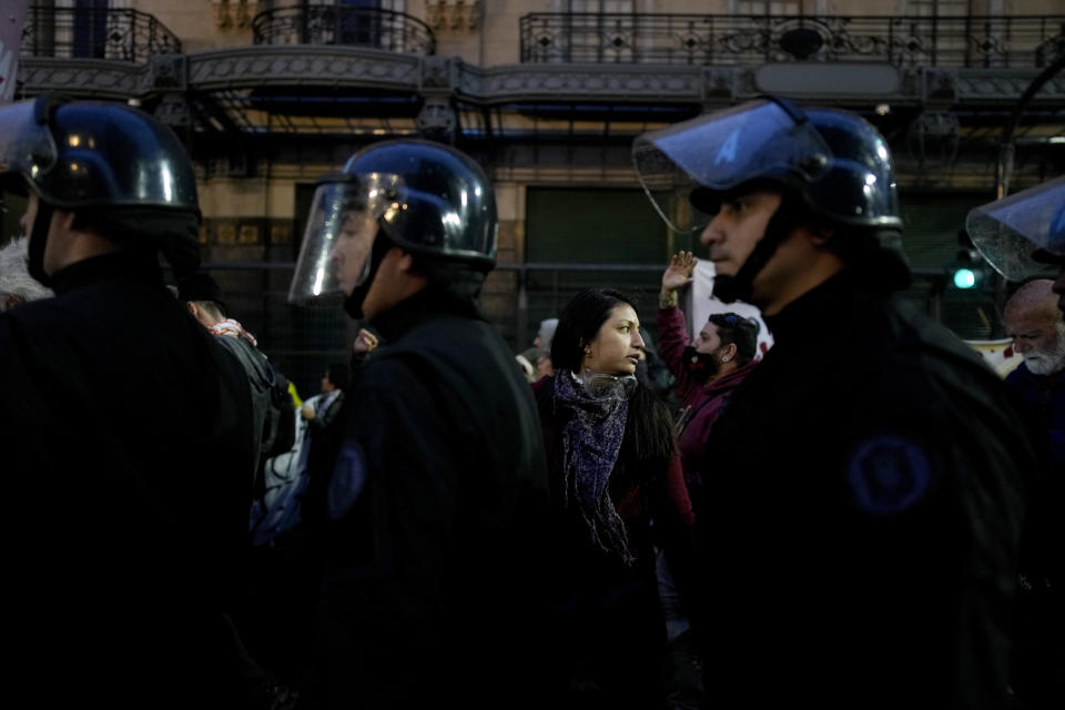 A woman protests against Argentine President Javier Milei's policies, including layoffs of state workers, outside Congress in Buenos Aires, Argentina, Friday, April 12, 2024. Milei's government has cut 15,000 state jobs over the past three months amid austerity measures. (AP Photo/Natacha Pisarenko)