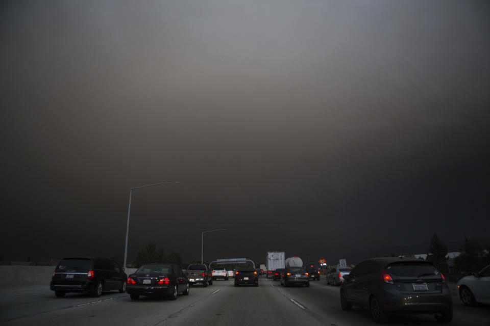 <p>Traffic makes their way south on I-15 as ash from the Holy Fire fills the air on Aug. 9, 2018 in Lake Elsinore, Calif. (Photo: Patrick Record/AP) </p>