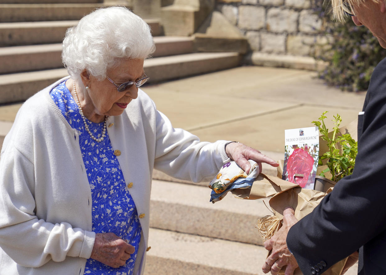 The Queen examining the floral tribute