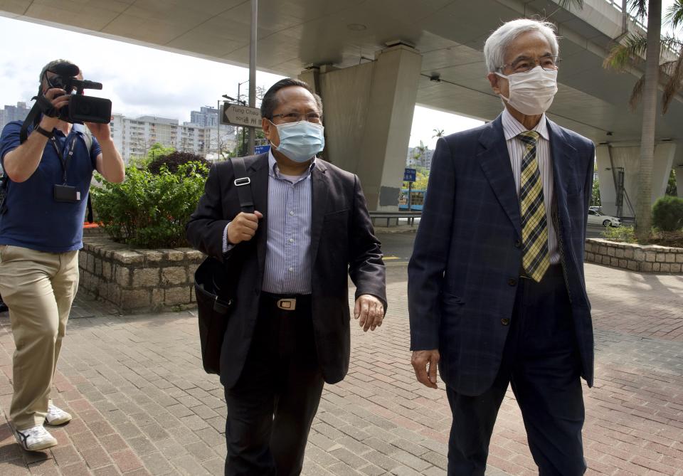 Pro-democracy lawmaker Martin Lee, center, and Albert Ho arrive at a court in Hong Kong Thursday, April 1, 2021. Seven pro-democracy advocates were convicted Thursday for organizing and participating in an unlawful assembly during massive anti-government protests in 2019, as Hong Kong continues its crackdown on dissent. (AP Photo/Vincent Yu)