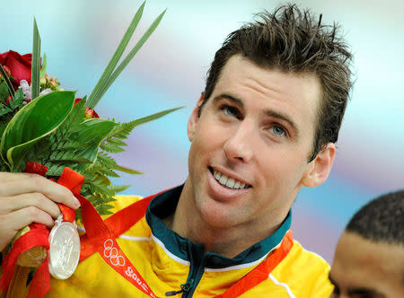 FILE PHOTO - Grant Hackett of Australia holds his silver medal for the men's 1500m freestyle swimming final at the National Aquatics Center during the Beijing 2008 Olympic Games, August 17, 2008. REUTERS/Kai Pfaffenbach/File Photo