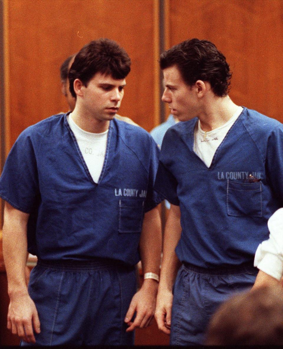 Lyle, left, and Erik Menendez converse in a Santa Monica, Calif. courtroom on Aug. 6, 1990.