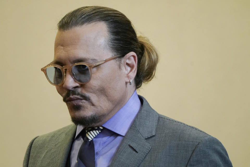 Actor Johnny Depp returns to the courtroom after lunch break at the Fairfax County Circuit Court in Fairfax, Va., Wednesday May 4, 2022. Depp sued his ex-wife Amber Heard for libel in Fairfax County Circuit Court after she wrote an op-ed piece in The Washington Post in 2018 referring to herself as a "public figure representing domestic abuse." (Elizabeth Frantz/Pool Photo via AP)