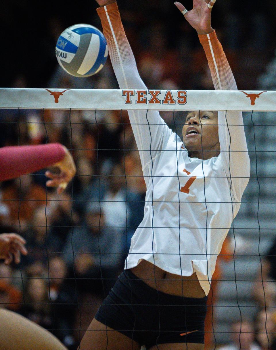 Texas middle blocker Asjia O'Neal leaps to block during the second set of a 3-1 win over Iowa State on Wednesday. The Horns clinched a seventh straight Big 12 title with two matches remaining in the regular season.