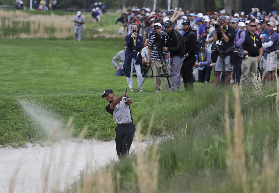 Tiger Woods hits out of a bunker on the 13th hole during the second round of the PGA Championship golf tournament, Friday, May 17, 2019, at Bethpage Black in Farmingdale, N.Y. (AP Photo/Charles Krupa)