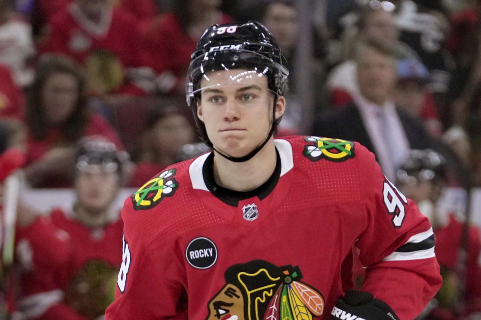 FILE - Chicago Blackhawks center Connor Bedard watches his teammates during the first period of an NHL preseason hockey game against the Detroit Red Wings, Oct. 3, 2023, in Chicago. Bedard, the 18-year-old top pick by the Blackhawks, makes his NHL debut on Tuesday, Oct. 10 when he faces Pittsburgh Penguins and star center Sidney Crosby, a top pick himself 17 years ago. (AP Photo/Charles Rex Arbogast, file)