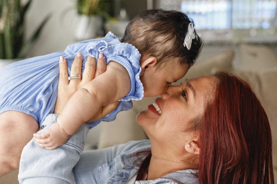 Victoria Cornejo Barrera, former head custodian for a high school in Columbia, South Carolina holds her four-month-old daughter Fernanda Cabrera at her home in Columbia, S.C., Monday, June 10, 2024. The Pregnant Workers Fairness Act entitled her to the types accommodations she had been seeking when she was pregnant. (AP Photo/Nell Redmond)