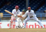 Australian batsman David Warner gets a four during the fourth day of the second-of-three Test matches between Australia and West Indies April 18, 2012 at Queen's Park Oval in Port of Spain, Trinidad.