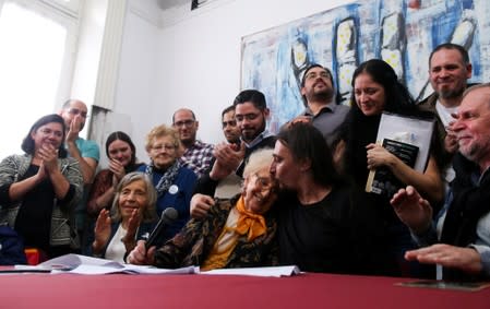 Javier Matias Darroux Mijalchuk, son of Elena Mijalchuk and Juan Manuel Darroux, who disappeared during Argentina's former 1976-1983 dictatorship, comforts the president of human rights organisation de Carlotto, during a news conference in Buenos Aires