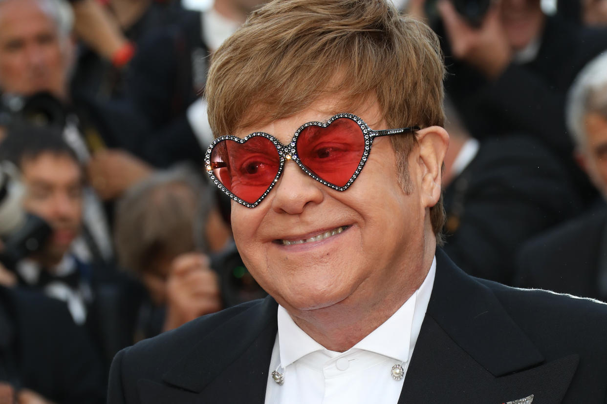  A headshot of Elton John wearing love-heart shaped glasses. 
