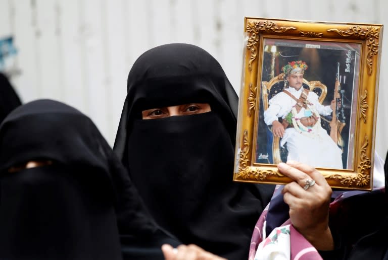A Yemeni protester holds a portrait of a relative during a demonstration calling for the release of prisoners being held in government prisons outside the Red Cross office in Sanaa, on July 26, 2017