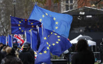 Anti Brexit protesters demonstrate as a the wind blows their EU and British flags near the Palace of Westminster in London, Wednesday, Jan. 16, 2019. British lawmakers overwhelmingly rejected Prime Minister Theresa May's divorce deal with the European Union on Tuesday, plunging the Brexit process into chaos and triggering a no-confidence vote that could topple her government. (AP Photo/Alastair Grant)