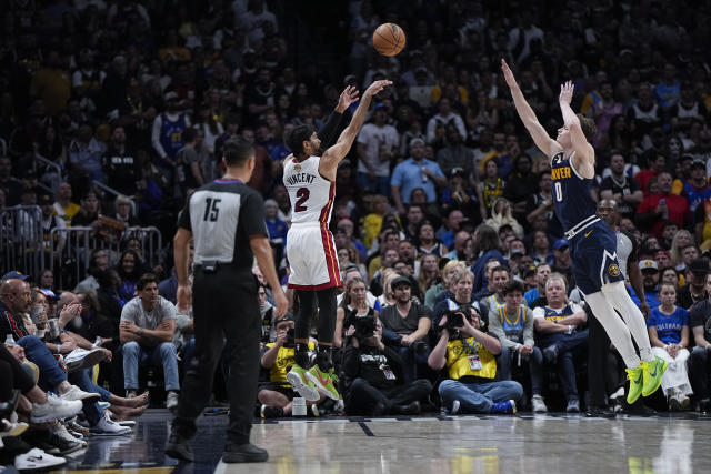 Miami Heat guard Gabe Vincent shoots a 3-pointer over Denver Nuggets guard Christian Braun during the second half of Game 2 of the NBA Finals on Sunday in Denver. (AP Photo/Mark J. Terrill)