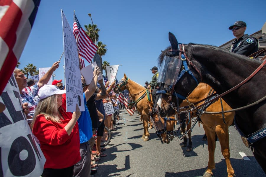 Police face protestors on May 1, 2020 in Huntington Beach. (Apu Gomes/Getty Images)