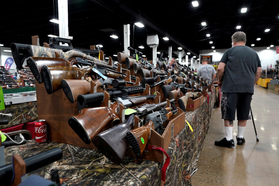 A man looks at rifles displayed for sale at the Guntoberfest gun show in Oaks, Pennsylvania, U.S., October 6, 2017. REUTERS/Joshua Roberts