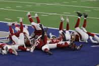 Members of the Arizona Cardinals defense act out a bowling pin strike dramatization after being hit by a ball rolled by Byron Murphy Jr. who intercepted a Dallas Cowboys quarterback Andy Dalton pass in the second half of an NFL football game in Arlington, Texas, Monday, Oct. 19, 2020. (AP Photo/Ron Jenkins)