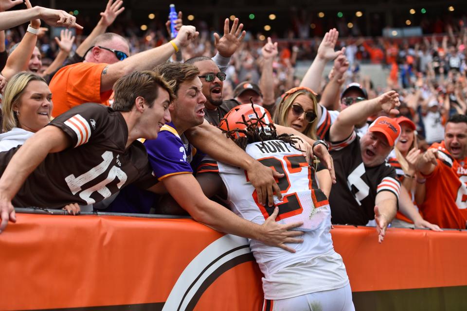 Browns running back Kareem Hunt (27) is mobbed by fans after he scored a 29-yard touchdown during the second half against the Chicago Bears, Sunday, Sept. 26, 2021, in Cleveland. (AP Photo/David Richard)