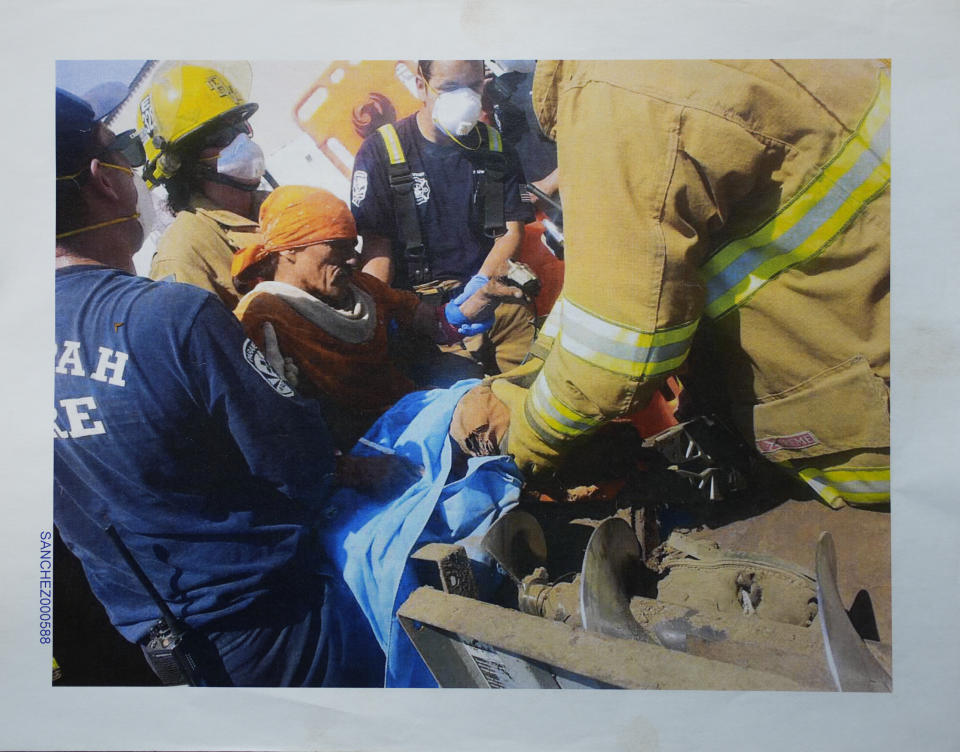 This 2015 photo shows first responders as they work to free Blas Sanchez from an auger that snagged and mutilated his right leg, at Hickman's Family Farms, in Tonopah, Ariz. Nationwide, prisoners are increasingly being placed in dangerous jobs, sometimes with little or no training. They are part of a labor system that, often by design, largely denies them basic rights and protections guaranteed to other American workers. (Provided by Blas Sanchez via AP)