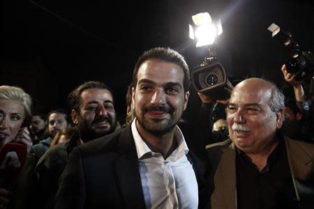 Radical leftist Syriza party candidate for the Athens' mayorship Gabriel Sakellaridis (C) arrives at his pre-election campaign kiosk in Athens May 18, 2014. REUTERS/Alkis Konstantinidis