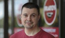 Owner Michael Kudrna poses in front of Frato's Pizza in Schaumburg, Ill., on Sept. 6, 2019. Frato's looks like a typical restaurant, but in the kitchen, cooks are whipping up dishes for four other restaurants at the same time. Kudrna launched the four spinoffs earlier this year in a matter of weeks as he races to keep his Chicago-area business ahead of a growing trend: restaurants conceived only for delivery or take-out. (AP Photo/Teresa Crawford)