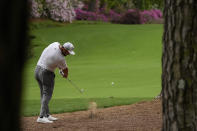 Jon Rahm, of Spain, hits out of the pine straw on the 13th hole during the second round of the Masters golf tournament on Friday, April 9, 2021, in Augusta, Ga. (AP Photo/Charlie Riedel)