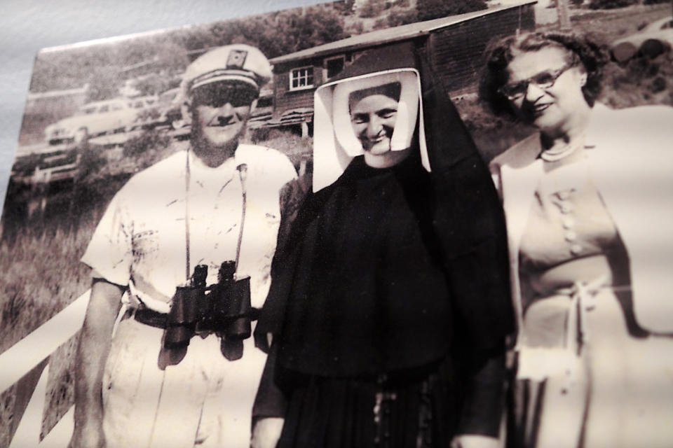 A photo of Sister Jean Dolores Schmidt, center, and her parents, hangs in a museum gallery dedicated to the now 103-year-old Catholic nun, at Loyola University on Tuesday, Jan. 24, 2023, in Chicago (AP Photo/Jessie Wardarski)