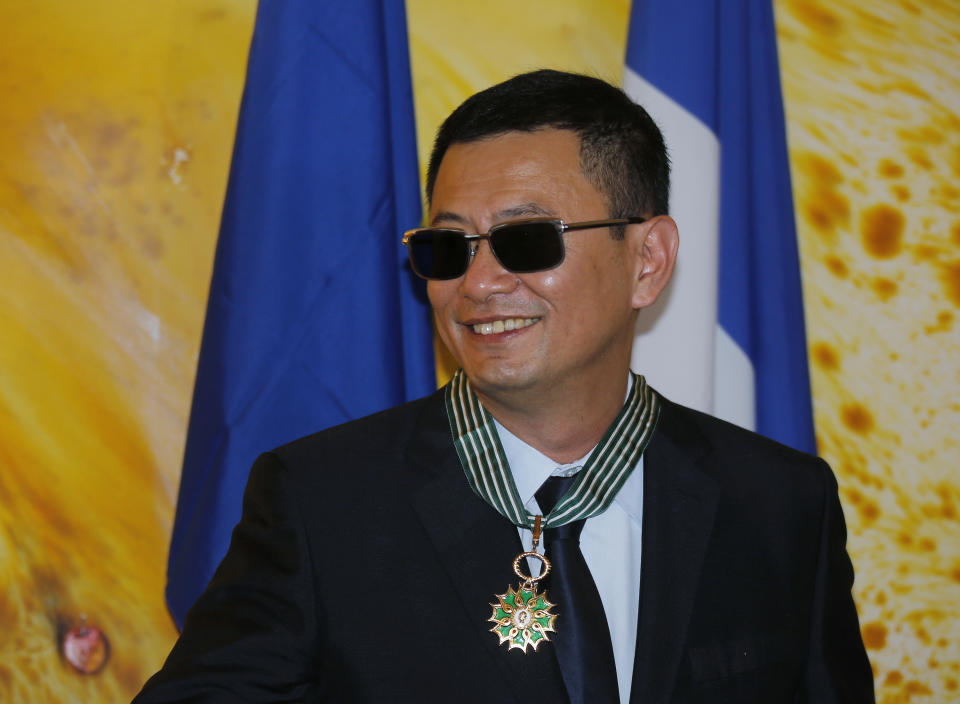 Hong Kong director Wong Kar-wai smiles after he received the Commandeur des Arts et Lettres from French Foreign Minister Laurent Fabius, in Hong Kong Sunday, May 5, 2013. Wong has been given France's highest cultural honor. (AP Photo/Vincent Yu)