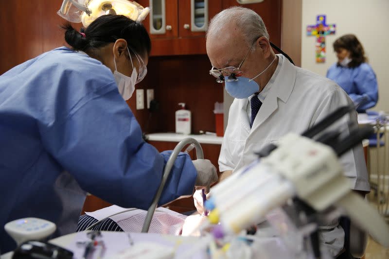 FILE PHOTO: Clients use dental services at the Spanish Catholic Center agency of the Diocese of Washington Catholic Charities in Washington