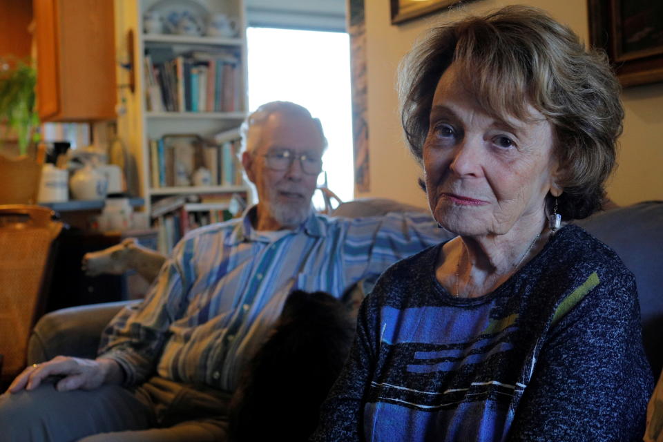 Cynthia Flagg (R) sits with her husband Charles, who took part in an early stage trial of Biogen's drug Aducanumab following his diagnosis with Alzheimer's disease, at their home in Jamestown, Rhode Island, U.S., February 21, 2020.  On June 7, 2021 the U.S. Food and Drug Administration (FDA) approved Aduhelm (aducanumab) as the first treatment to target a likely underlying cause of Alzheimer's disease - sticky deposits of a protein called amyloid beta.  Picture taken February 21, 2020.    REUTERS/Brian Snyder